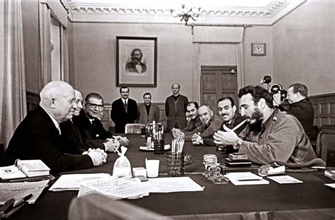 Fidel Castro smoking a cigar and wearing two Rolex watches .